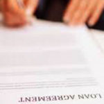 person signing a loan agreement