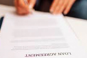 person signing a loan agreement